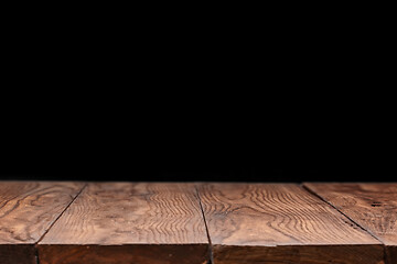 Image showing Empty wooden table backdrop on a black background.