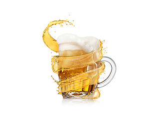 Image showing Refreshing beer glass mug with thick foam and flying splash.