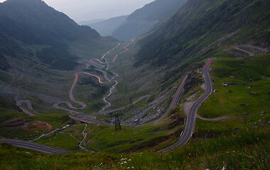 Image showing Curvy road in mountains, traffic lights