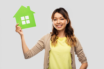 Image showing happy asian woman with green house