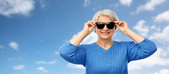 Image showing smiling senior woman in black sunglasses