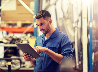 Image showing auto mechanic or smith with tablet pc at workshop