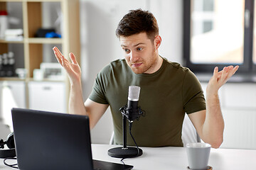 Image showing man with laptop and microphone at home office