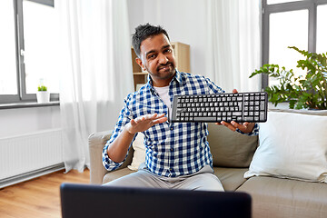 Image showing male blogger with keyboard videoblogging at home