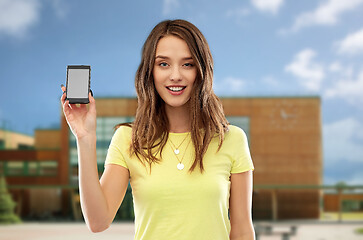 Image showing teenage girl holding smartphone over school