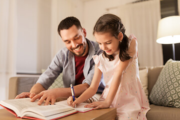 Image showing father and daughter doing homework together