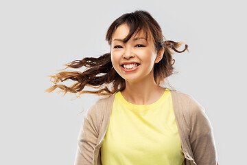 Image showing happy asian woman with waving hair