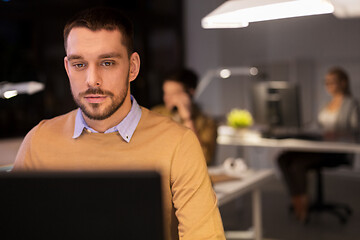 Image showing man with computer working late at night office