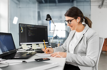 Image showing businesswoman with notebook working at office