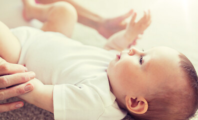 Image showing close up of happy little baby and mother hands