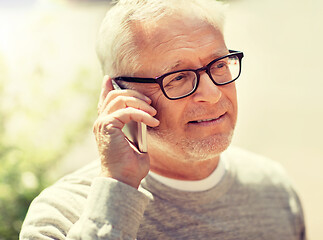 Image showing happy senior man calling on smartphone in city