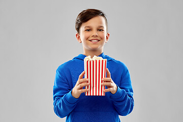 Image showing happy smiling boy in blue hoodie with popcorn