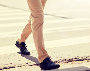 Image showing senior man walking along city crosswalk