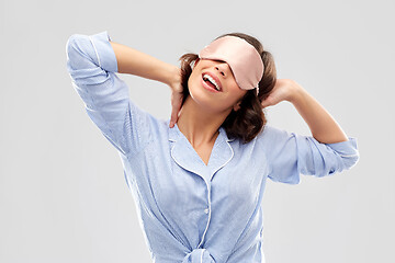 Image showing happy young woman in pajama and eye sleeping mask