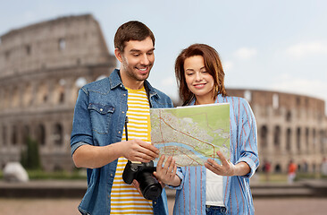 Image showing happy couple of tourists with map and camera