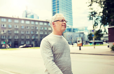 Image showing senior man walking along summer city street