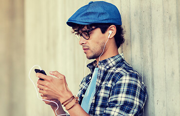 Image showing man with earphones and smartphone listening music