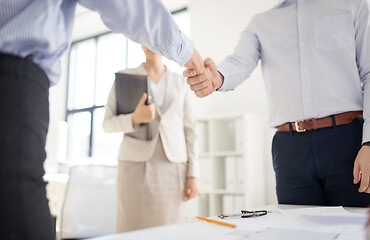 Image showing close up of businessmen making handshake at office