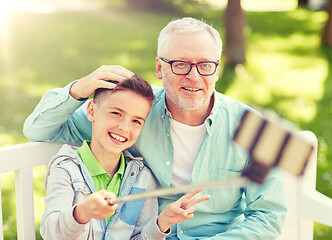 Image showing old man and boy taking selfie by smartphone