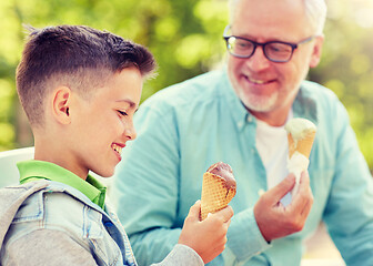 Image showing old man and boy eating ice cream at summer park