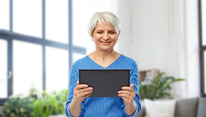 Image showing senior woman using tablet computer at home