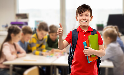 Image showing student boy with books and bag showing thumbs up