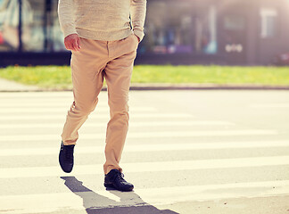 Image showing senior man walking along city crosswalk