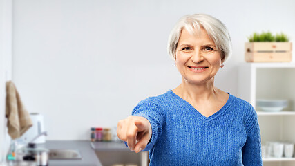 Image showing senior woman pointing finger to you at kitchen