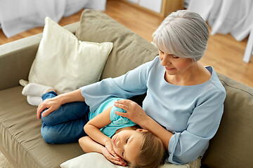 Image showing grandmother and granddaughter resting on pillow