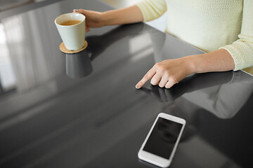 Image showing woman with coffee using black interactive panel