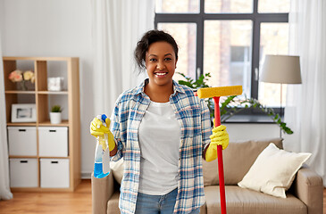 Image showing african woman with window detergent and sponge mop