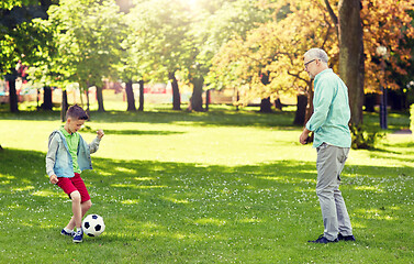 Image showing old man and boy playing football at summer park