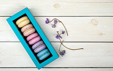 Image showing Macaroons in gift box next to violet