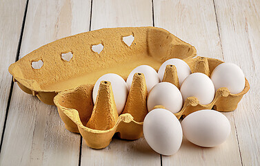 Image showing Eggs near the tray on white table