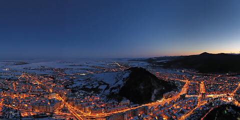 Image showing Aerial view after sunset, city lights and mountains