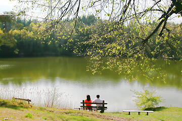 Image showing Couple on bench near the lake