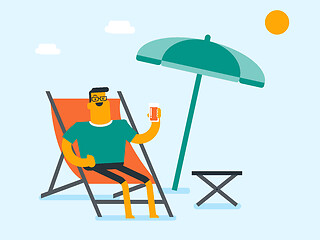 Image showing Young caucasian man relaxing on the beach chair.