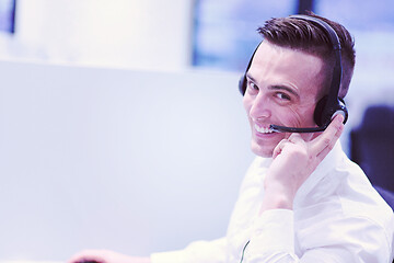 Image showing male call centre operator doing his job