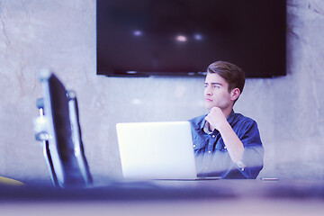 Image showing businessman working using a laptop in startup office