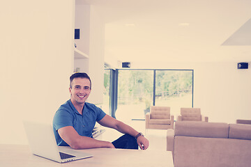 Image showing Young man with laptop at home