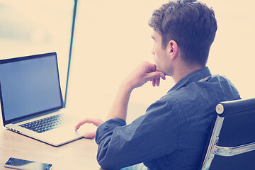 Image showing businessman working using a laptop in startup office