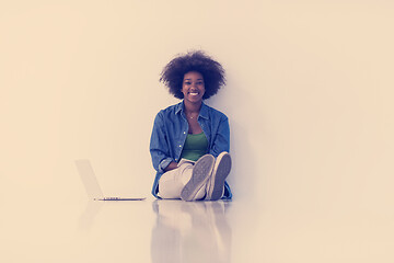 Image showing african american woman sitting on floor with laptop