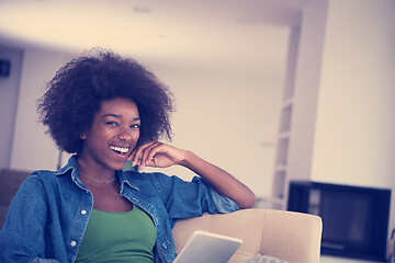 Image showing african american woman at home with digital tablet