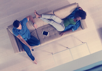 Image showing multiethnic couple relaxes in the living room top view