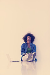 Image showing african american woman sitting on floor with laptop