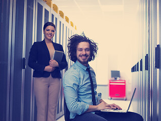 Image showing Team of young technicians working together on servers