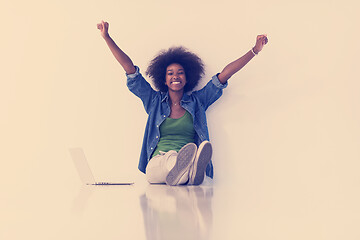 Image showing african american woman sitting on floor with laptop