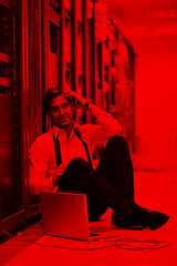 Image showing businessman with laptop in network server room