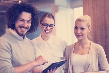 Image showing Business People Working With Tablet in startup office