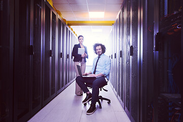 Image showing Team of young technicians working together on servers